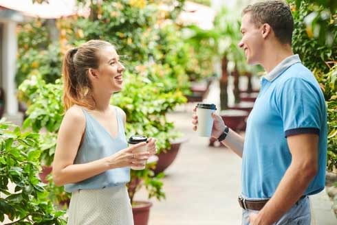 male and female date drinking coffee and conversing